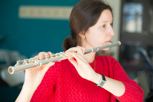istock Young women playing piano and flute 1135091180