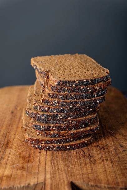 Studio shot of a sliced loaf of rye bread made with organic rye wheat, Colour, vertical with some copy space.