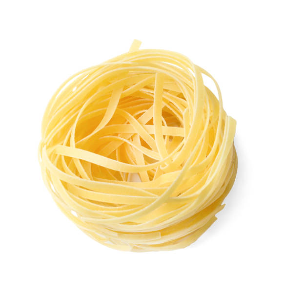 istock Noodles tagliatelle. One nest. White isolated background. 1135093249