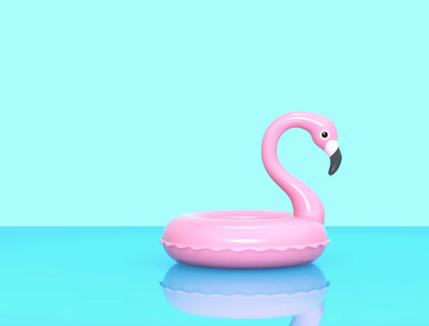 istock Inflatable pink flamingo on blue reflective surface 1135093931