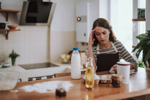 istock Tired young lady is cooking at home 1135095979