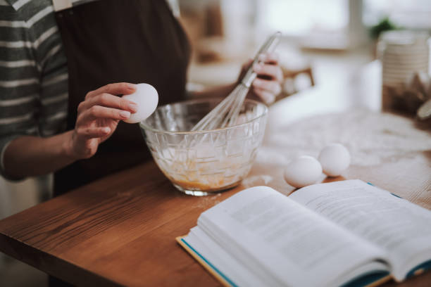 istock Woman is whisking eggs on kitchen at home 1135095982