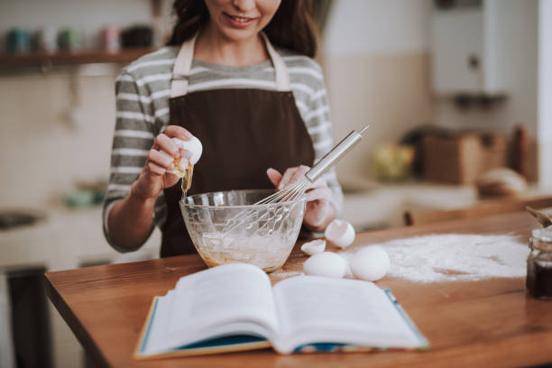 istock Happy lady is preparing dough in kitchen 1135095983