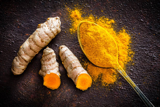 istock Spices: Turmeric roots and powder shot from above 1135096232