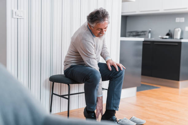 istock Senior man putting on his shoes 1135096767