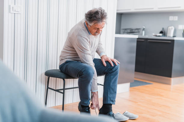 istock Senior man putting on his shoes 1135096769