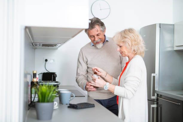 istock Senior couple making coffee together in the kitchen 1135097231