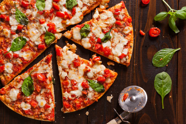istock Overhead view of a fresh vegetarian pizza with fresh basil 1135097234
