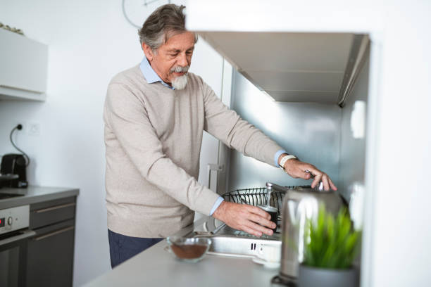 istock Senior man preparing spaghetti for lunch in the kitchen 1135097235