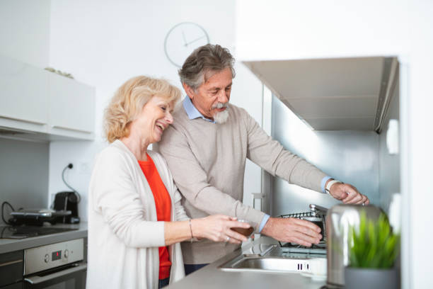 istock Senior couple making coffee together in the kitchen 1135097239