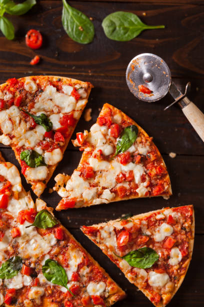 istock Overhead view of a fresh pizza with fresh basil and tomato 1135097248