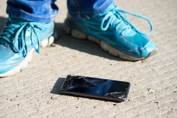 istock cellphone with broken screen is on the concrete floor after falling down 1135098335