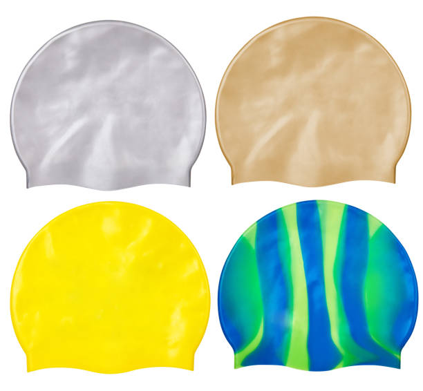 caps for swimming Set of different caps for swimming from rubber or silicone, on a white background isolated. Silver, golden, yellow and green and yellow striped caps swimming cap stock pictures, royalty-free photos & images