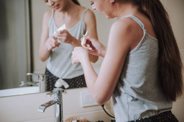 istock Pleasant young woman using gel in the bathroom 1135098556