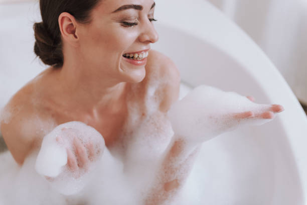 istock Positive smiling woman enjoying taking daily bath 1135098574
