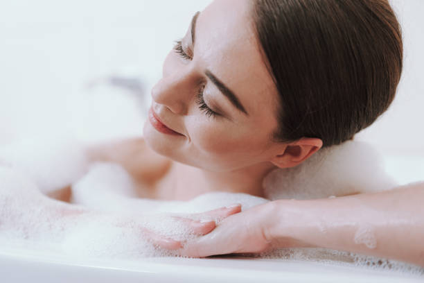 istock Close up of a delighted woman taking bath 1135098576