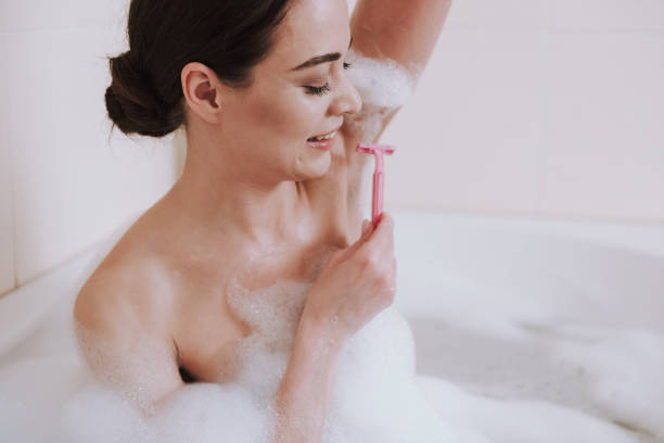 istock Nice young woman is shaving her armpits 1135098584