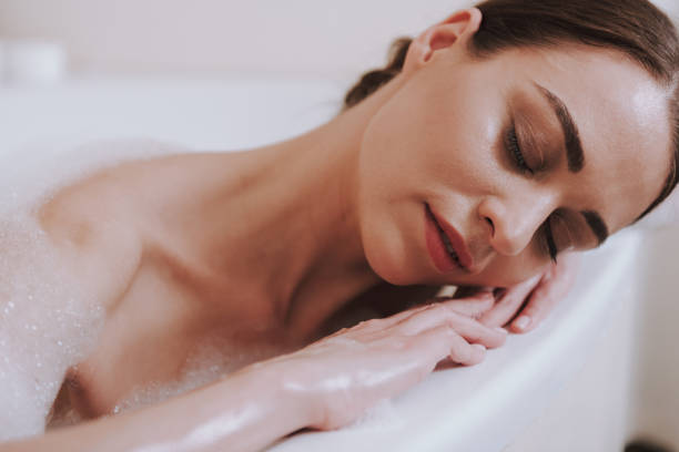 istock Delighted nice woman relaxing in the bathroom 1135098586