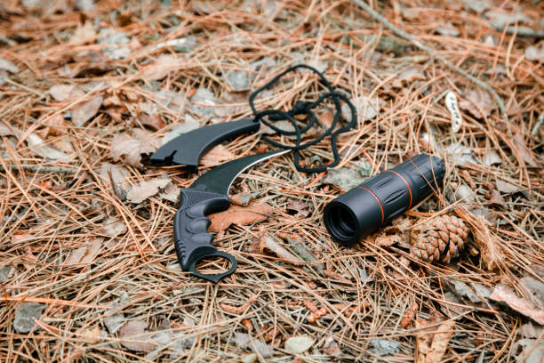 istock monocle and karambit knife on the ground covered with pine needles 1135100161