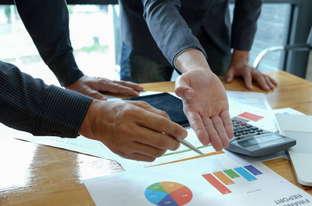 istock Male businessteam hands work on calculator and tablet in the office. 1135100344