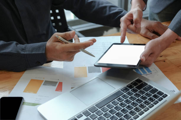 istock Male businessteam hands work on calculator and tablet in the office. 1135100353