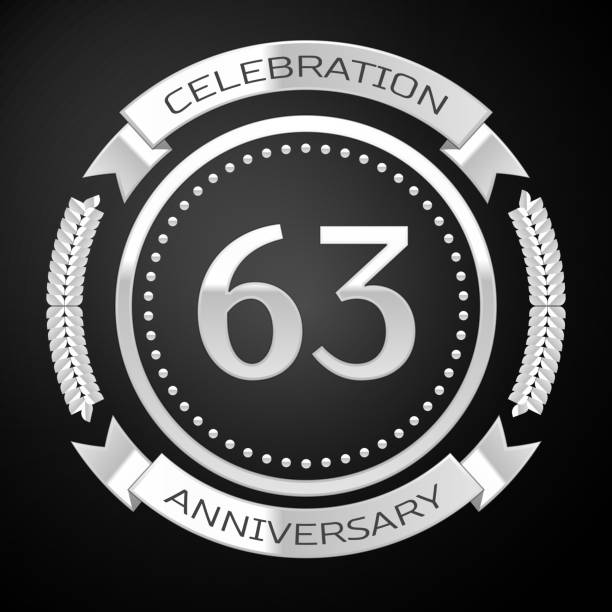 istock One Years Anniversary Celebration Design. Silver ring and ribbon on black background. Colorful Vector template elements for your birthday party 1135100523
