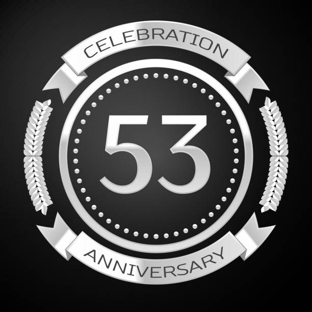 istock One Years Anniversary Celebration Design. Silver ring and ribbon on black background. Colorful Vector template elements for your birthday party 1135100576