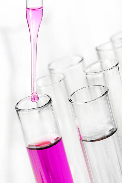 istock liquid dripping from pipette into test tube 113510088