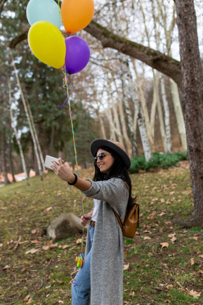istock She is taking picture with her birthday present- helium balloons 1135102338