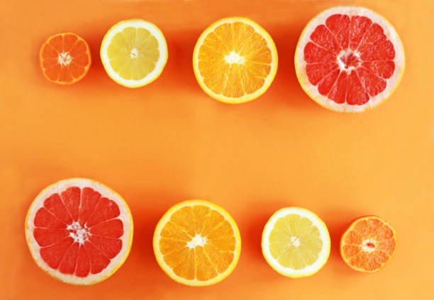 istock halved citrus fruits on orange colored background 1135102631
