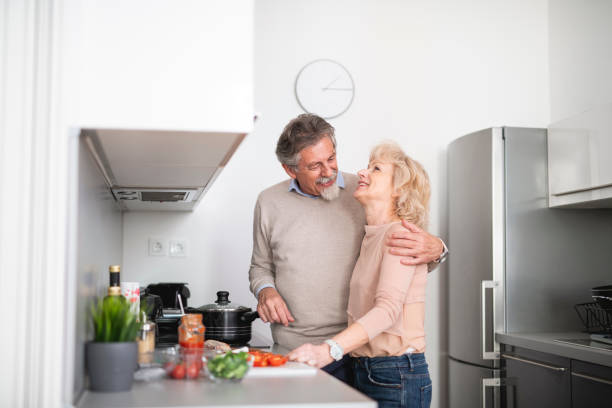 istock Senior couple preparing lunch together in the kitchen 1135102970