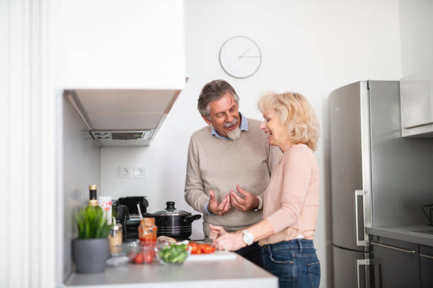 istock Senior couple preparing lunch together in the kitchen 1135103019