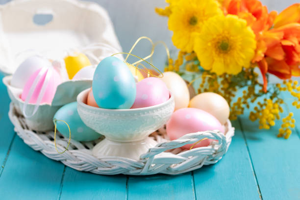 istock Easter eggs in egg cartoon box on blue rustic wooden background 1135103038