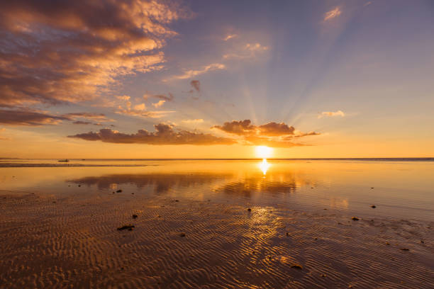 istock sunset at a beach, the sea in low tide 1135104910
