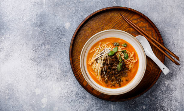 istock Ramen asian noodle in broth with minced chicken in soy paste and leek on gray background copy space 1135104944
