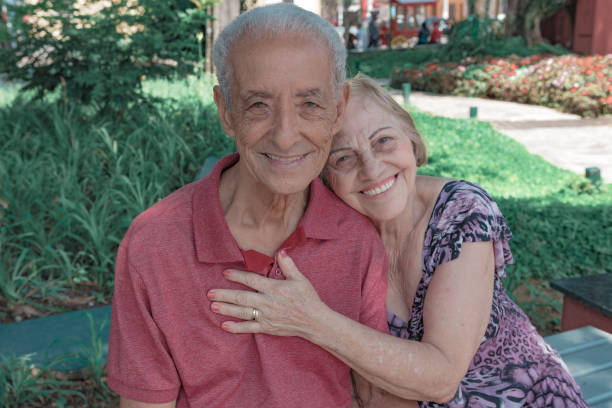 Smiling, looking couple and woman lying on man's shoulder
