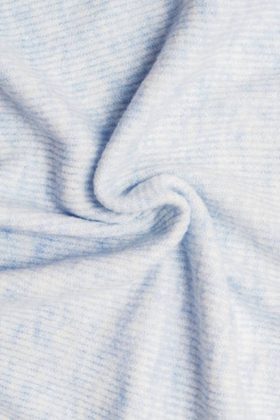 istock Sweater or scarf texture large knitting. Knitted jersey background with a relief pattern. Braids in knitting. Wool hand-knitted or machine knitting pattern. Fabric Background. 1135109391