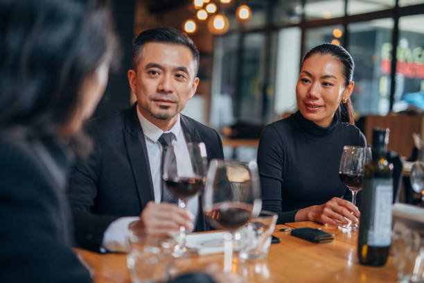 istock Elegant business people sitting in restaurant 1135109600