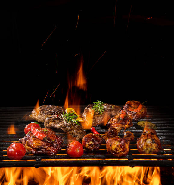 istock Chicken legs, wings and steaks on the grill. 1135110790