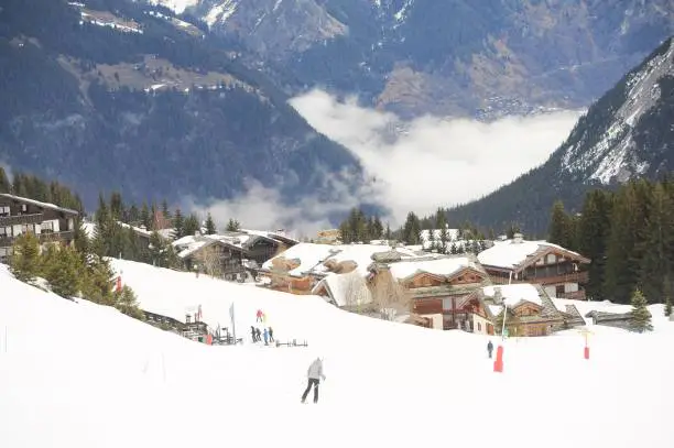 Courchevel ski resort in winter with village and skiing people