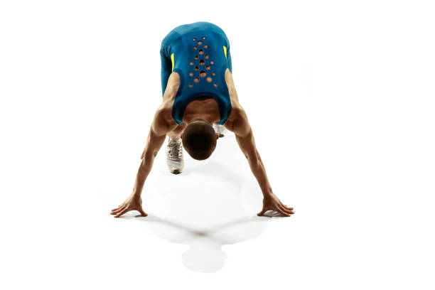 Young caucasian man preparing to run isolated on white studio background. One male runner or jogger. Silhouette of jogging athlete with shadows.