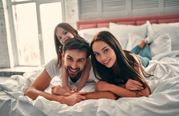 istock Happy family in bed 1135112614