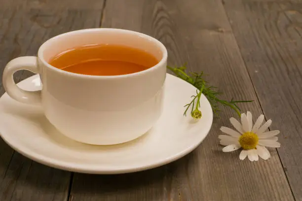 organic camomile herbal tea on rustic table