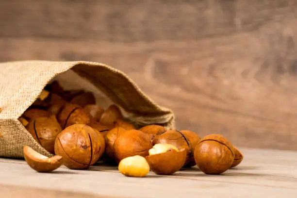 macadamia nuts on wooden background