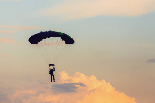 istock parachuting sport in sunset sky 1135116101