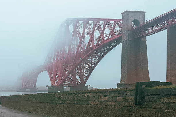 Old bridge in scotland covered by morning fog.