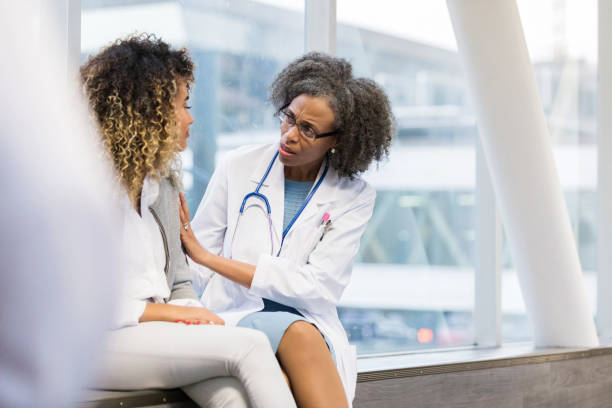 istock Mature female doctor shows concern for friend 1135117938