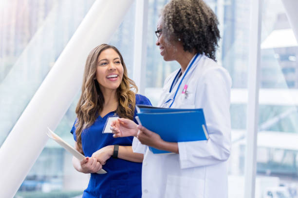 istock Medical professionals enjoy conversation in elevated walkway 1135117955