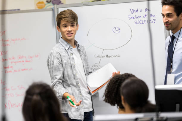 istock Teenage boy gives science class presentation 1135117981