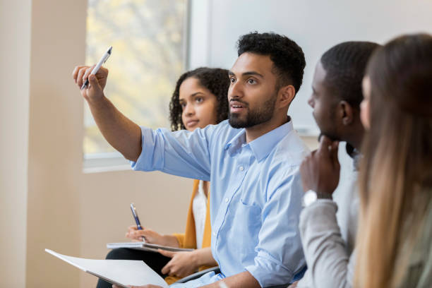 istock Businessman raises hand to ask question during conference 1135118236